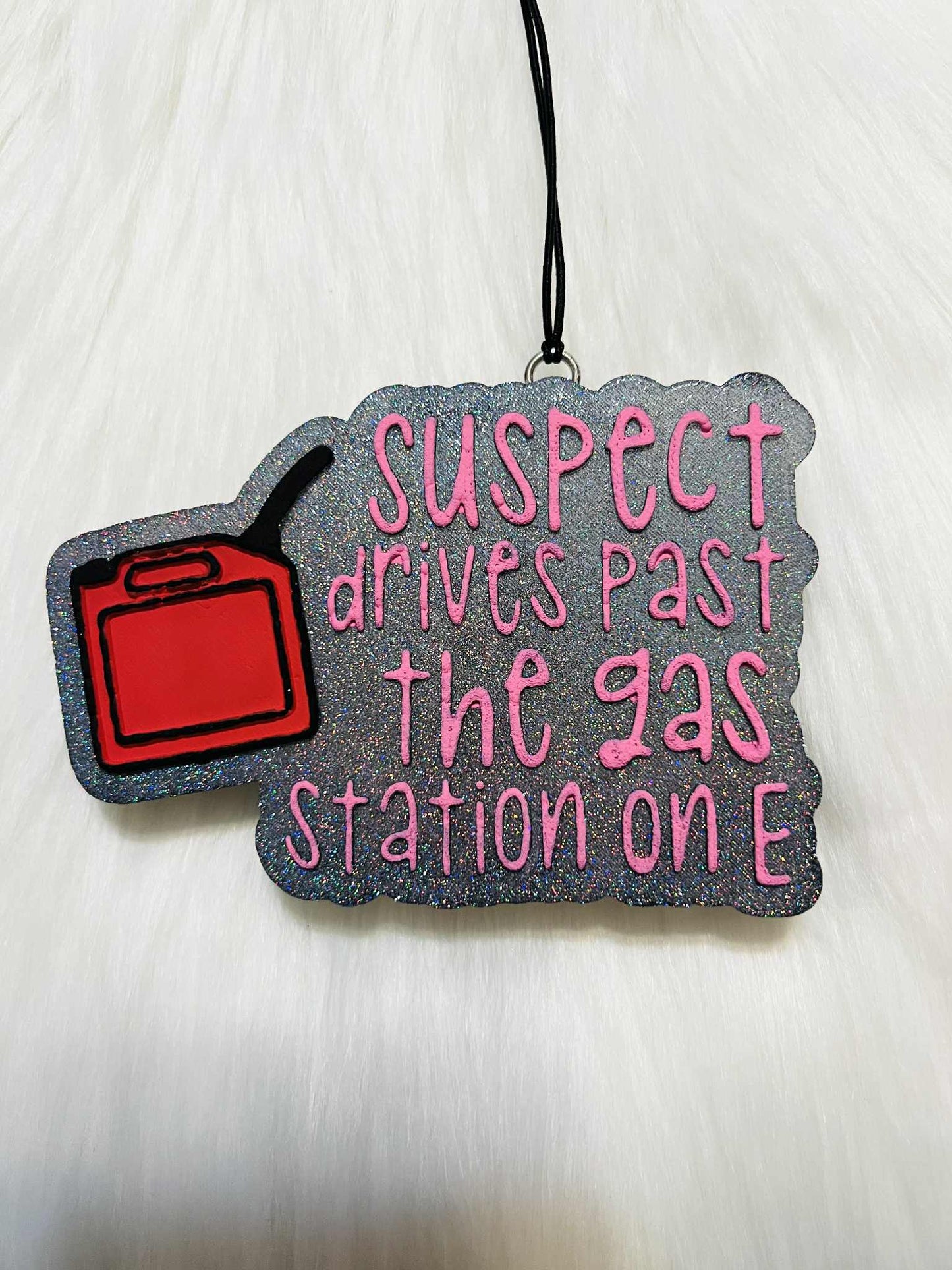 Suspect drives past the gas station on e car freshie
